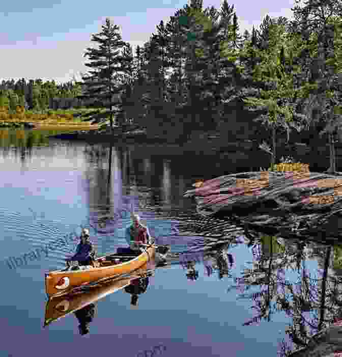 A Canoe Gliding Through The Tranquil Waters Of The Boundary Waters A Boundary Waters History: Canoeing Across Time