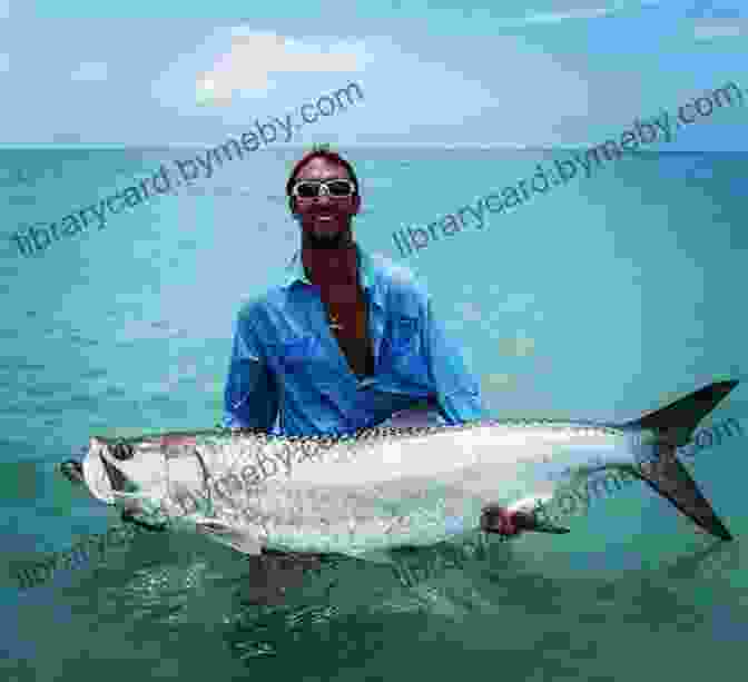 A Fisherman Holds Up A Large Tarpon He Caught On A Fly Rod. High Rollers: Fly Fishing For Giant Tarpon