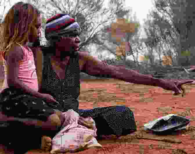 An Aboriginal Elder Holding A Young Child, Surrounded By The Harsh Conditions Of The Australian Desert Unexpected Journeys: LIFE S LESSONS FROM REMOTE AUSTRALIAN ABORIGINAL AND NATIVE AMERICAN COMMUNITIES