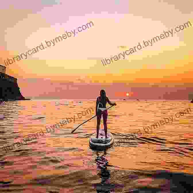 Paddler Admiring A Vibrant Sunset Over A Calm Lake Paddling Pennsylvania: A Guide To 50 Of The State S Greatest Paddling Adventures (Paddling Series)